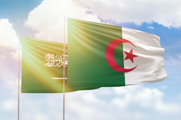Sunny blue sky and flags of algeria and saudi arabia