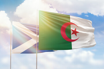 Sunny blue sky and flags of algeria and scotland