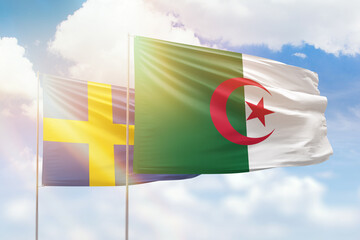 Sunny blue sky and flags of algeria and sweden