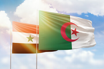 Sunny blue sky and flags of algeria and syria