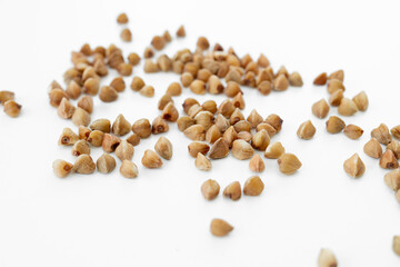 Close up of buckwheat grains isolated on white background. Top view