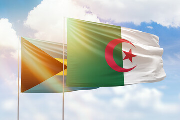 Sunny blue sky and flags of algeria and bahamas