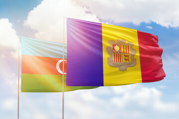 Sunny blue sky and flags of algeria and azerbaijan