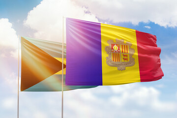 Sunny blue sky and flags of algeria and bahamas