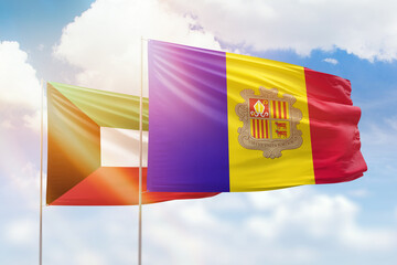 Sunny blue sky and flags of algeria and kuwait