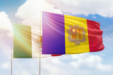 Sunny blue sky and flags of algeria and mexico