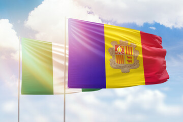 Sunny blue sky and flags of algeria and nigeria