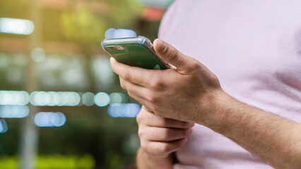 Hands of an unrecognizable person holding a cell phone.