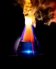 Strong chemical reaction with a lot smoke and vapors inside Erlenmeyer flask. Ignition is starting....