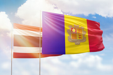 Sunny blue sky and flags of algeria and thailand