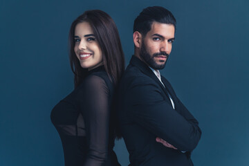 Equality at work. Young professional beautiful business couple looking at camera and being positive and serious. Studio shot. High quality photo