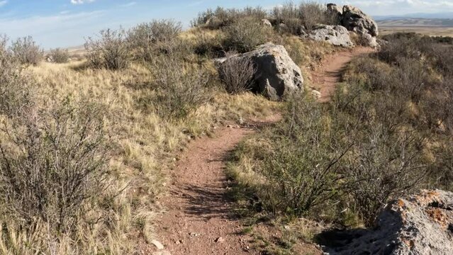First person POV  from riding mountain bike on a single track trail in Colorado, early spring scenery in Soapstone Prairie Natural Area