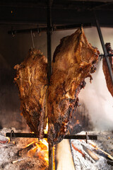 Argentine beef ribs slowly cooking to the flames