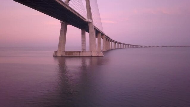 Aerial view of Lisbon Vasco da Gama Bridge in a beautiful Sunset