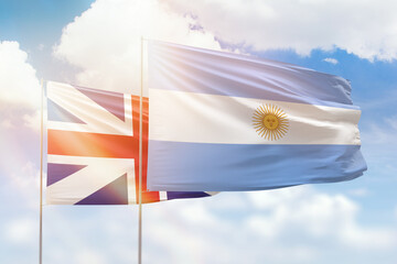 Sunny blue sky and flags of argentina and great britain