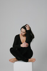 Calm middle-aged woman looking way posing on white wall. Mental health issues.