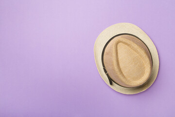 Straw hat on color background, top view