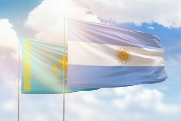 Sunny blue sky and flags of argentina and kazakhstan
