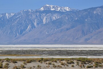 Fototapeta na wymiar Snow covered mountains of the Sierra Nevada range viewed from Death Valley National Park in California