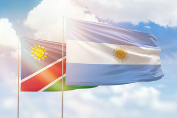 Sunny blue sky and flags of argentina and namibia