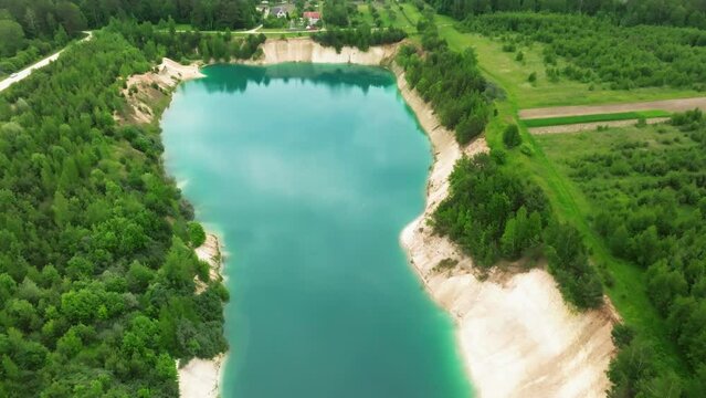 ariel top view of an old flooded lime quarry with turquoise water