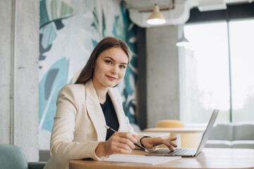 Businesswoman using laptop in office