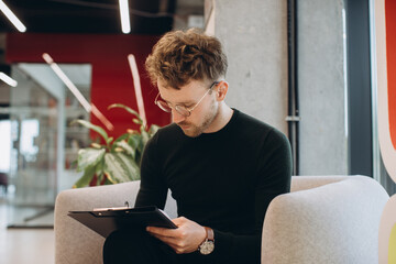 Businessman edits a report before the meeting