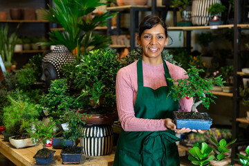 Portrait of a successful and confident latin american woman florist standing in a store with...