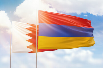 Sunny blue sky and flags of armenia and bahrain