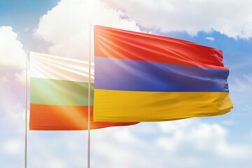 Sunny blue sky and flags of armenia and bulgaria