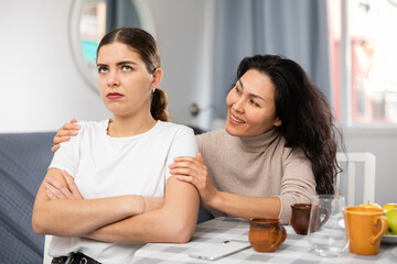 Annoyed stressed woman ignoring girlfriend after quarreling at home, LGBTQ relationship problems concept