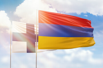 Sunny blue sky and flags of armenia and finland