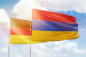 Sunny blue sky and flags of armenia and germany