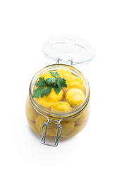 Marinated yellow squash in glass jar isolated on white