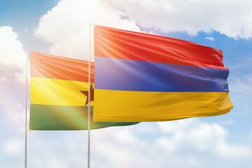 Sunny blue sky and flags of armenia and ghana