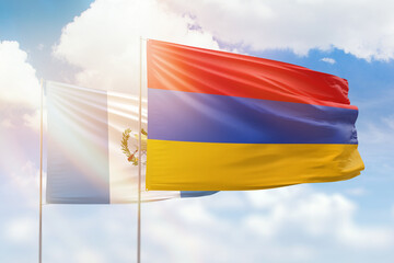 Sunny blue sky and flags of armenia and guatemala