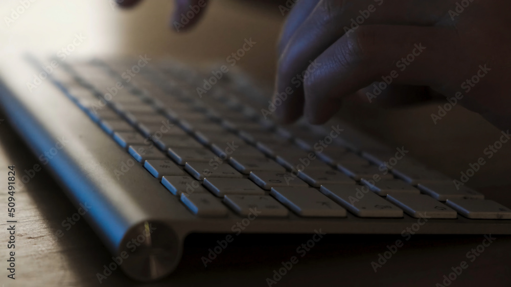 Poster close-up of man's hands typing on the keyboard. concept. men's hands type text on the keyboard at ni