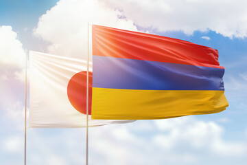 Sunny blue sky and flags of armenia and japan