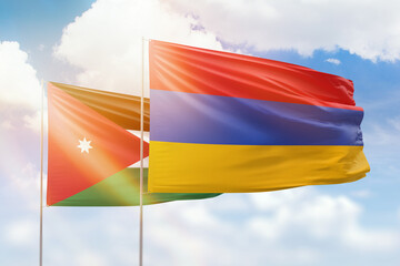Sunny blue sky and flags of armenia and jordan