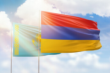 Sunny blue sky and flags of armenia and kazakhstan