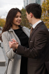 a beautiful young couple walking around the city.man and woman in business style