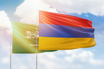 Sunny blue sky and flags of armenia and saudi arabia
