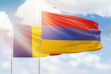 Sunny blue sky and flags of armenia and romania