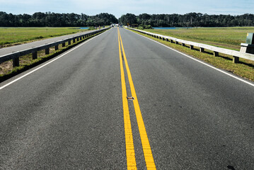 asphalt road with yellow markings.