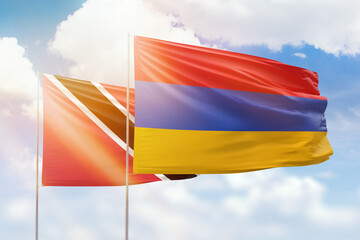 Sunny blue sky and flags of armenia and trinidad and tobago