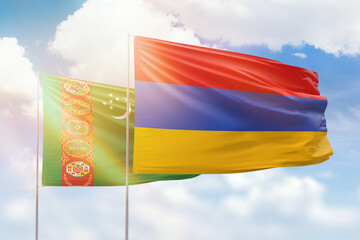 Sunny blue sky and flags of armenia and turkmenistan