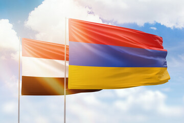 Sunny blue sky and flags of armenia and yemen