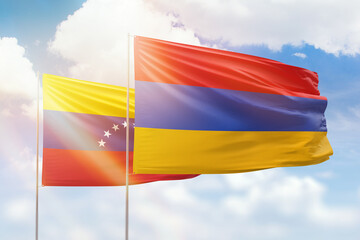 Sunny blue sky and flags of armenia and venezuela