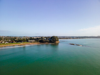 Spectacular beachfront properties seen aerially from the sky by drone in Red beach, New Zealand 
