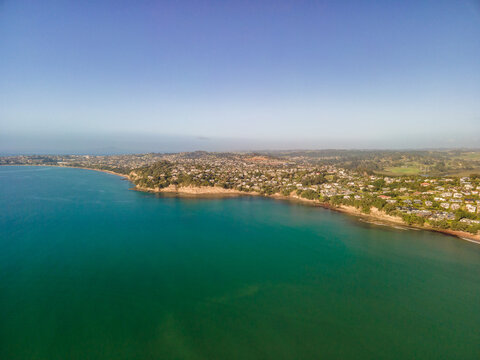 Spectacular beachfront properties seen aerially from the sky by drone in Red beach, New Zealand 